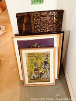 All four pieces stacked, showing copper plaque and two framed needlepoints
