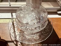 Stacked clear glass platter, bowls and bud vases