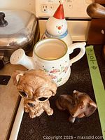 Group photo showing snowman jar, floral jug, two dog figurines