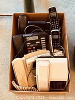 Box containing assorted phones