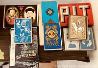 Overview of ten assorted playing-card decks on shelf