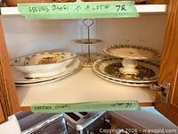 Cabinet view showing all serving pieces on two shelves