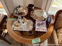 Overall lot on round table showing majority of pieces
