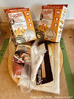 Group view of all boxed kitchen items on round wooden tray