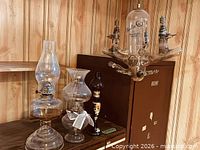 Group shot showing three kerosene lamps and Navilin vacuum tube