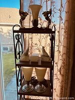 Full view of lamp, small lamps, and marble bookends on shelf