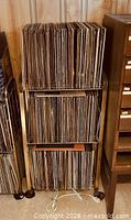 Full view of three-tier stand loaded with vinyl records
