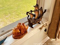 Front view showing both ship items on windowsill