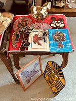 Group shot showing variety of stained glass pieces on table and floor