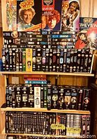 Full shelving unit showing VHS, DVDs, books and standees