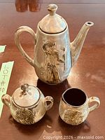 Teapot, sugar bowl with lid, creamer, showing full set