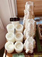 Group view of six LED candles, remote, and three carved unity candles