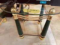 Full view showing glass top and green/brass legs