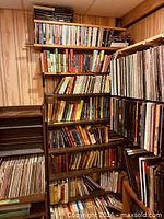 Full view of bookcase loaded with books and vinyl records