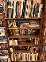 Full view of wooden bookcase filled with books