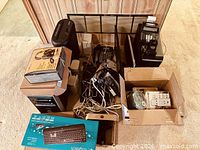 Overall lot showing shredder, computer tower, monitors, telephone, boxed peripherals and cables