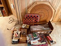 Group shot showing crokinole board, grid boards, games and crate