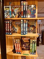 Shelf showing Batman, Supergirl, Superman, Justice League, World’s Finest Showcase Presents volumes