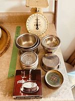 Scale, bowls and coaster sets grouped on counter