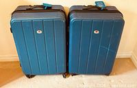 Front view of both blue hardside spinner suitcases