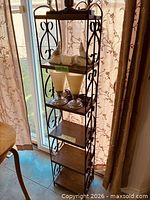 Full view of metal stand showing four wood shelves and top