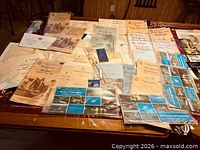 Overview of all nautical charts, guides and tools spread on table