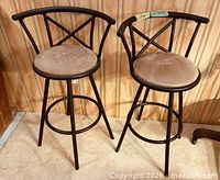 Both bar stools front view against wall