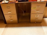 Front view of both metal file cabinets under desk, shows drawer arrangement