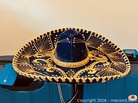 Front angled view of sombrero showing blue velvet and gold embroidery