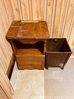 nightstand and wastebasket together in corner