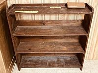 Front view of wood bookcase with three fixed shelves