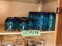 Group of blue tumblers upside-down on shelf