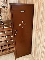 Front view of brown metal cabinet closed