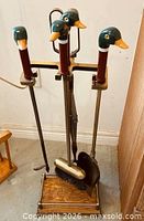 Full view of stand with duck-head handles on tools