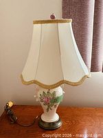 full view of lamp with shade on wooden surface