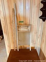 Full view of washboard and two yardsticks leaning against wall