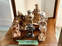 Group shot of all eight caricature figurines on shelf