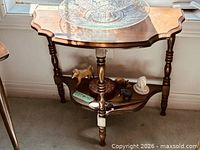 Front view of scalloped mahogany demi-lune console table showing top and lower shelf