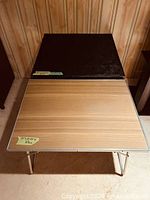 Overhead view showing both folding tables, surfaces and legs