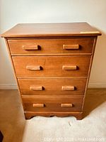 Front view of four-drawer maple chest