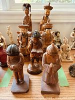 All seven wooden figurines displayed together