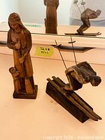 Both wooden sculptures side by side