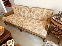 Full front view of floral upholstered sofa