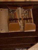 open case showing instruments and syringe
