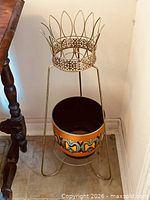 Full view of metal stand with ceramic pot