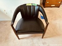 Front view of accent chair showing overall form and materials