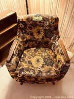 Front view of floral upholstered armchair showing overall condition