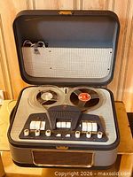 Overall view of tape recorder with lid open showing reels and control panel