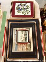 Boxed set showing nested placemats, coasters and separate fruit motif mat