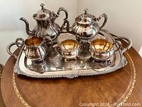 Full six-piece silver-plated set displayed on tray